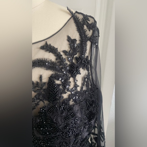 Terani Couture Embroidered Long Sleeve Front Slit Ruffled Mermaid Gown.